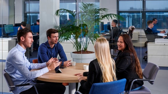 Outsourcing accounts receivable management. Four people consulting with each other